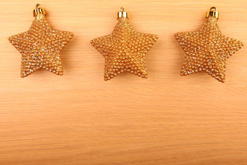 Fototapeta na wymiar New year gold stars wooden table