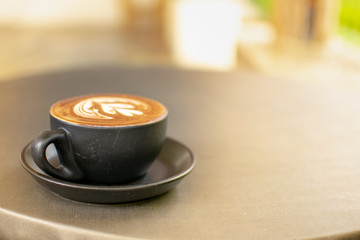 Black coffee cups placed on a gray table.