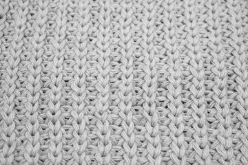 Texture of knitted sweater closeup, white knitted wool