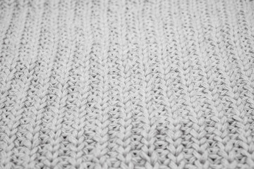 Texture of knitted sweater closeup, white knitted wool