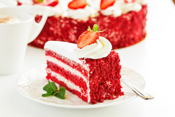 a piece of delicious red velvet cake on a plate.