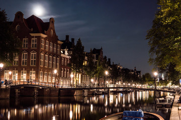 Fototapeta na wymiar Night city view of Amsterdam channel and typical dutch houses, Holland, Netherlands.