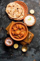 Murgh Makhani / Butter chicken tikka masala served with roti / Paratha and plain rice along with onion salad. selective focus