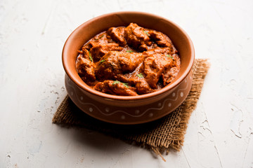 Murgh Makhani / Butter chicken tikka masala served with roti / Paratha and plain rice along with onion salad. selective focus