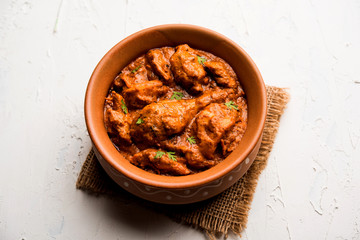 Murgh Makhani / Butter chicken tikka masala served with roti / Paratha and plain rice along with onion salad. selective focus