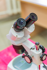 Laboratory Equipment, Optical Microscope for school lessons on red table