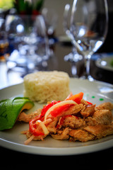 Typical Caribbean food with chicken, rice and mango in a restaurant.