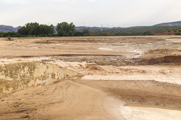 Muddy flood and water streams cover the croplands after historic storm that hit the south of Seville and north of Malaga province, in Spain.