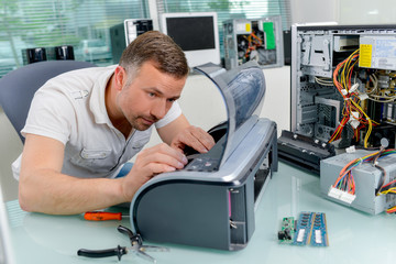 techinician fixing a printer