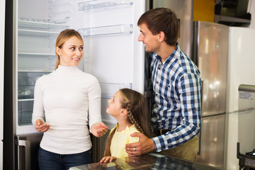 Family choosing refrigerator in store