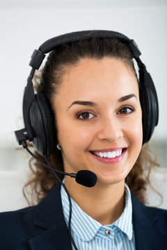 Happy woman call center operator talking with client