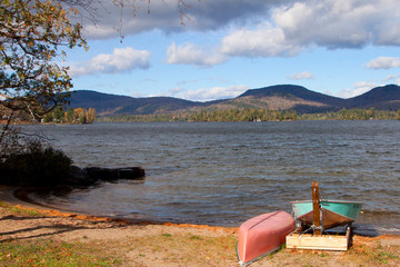 Canoes by the Lakeshore with hills in the background
