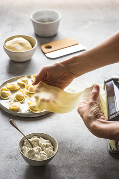 Crop person making natural tortellini