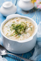 Tasty mushroom soup with noodles on a wooden table.