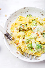 homemade pumpkin pasta tagliatelle with broccoli and pesto
