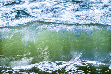 Breaking waves of clear green water