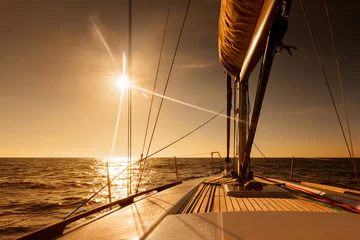 Rolgordijnen Sailing towards sunset at open sea © thakala