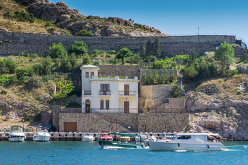 Pier in the sea bay. Russia, Republic of Crimea, Balaclava. 11.06.2018: Pleasure boats in...