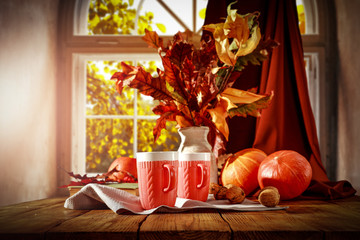 Autumnal leaves on a wooden table in the afternoon day   