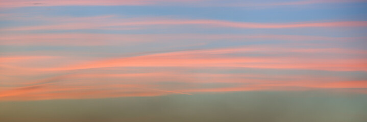 Panoramic view of a beautiful pink sky at sunset with soft clouds
