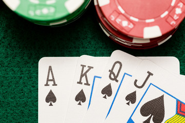 Casino chips and poker cards on green table