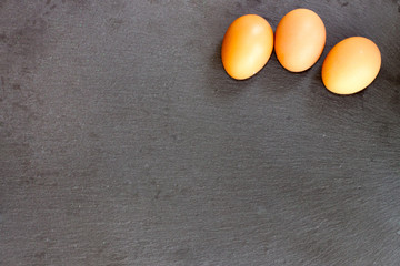 Eggs on black background with empty space