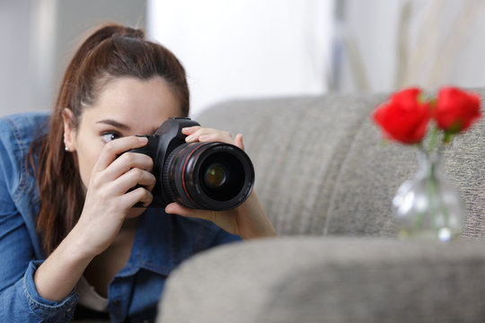 female photographer taking pictures indoors