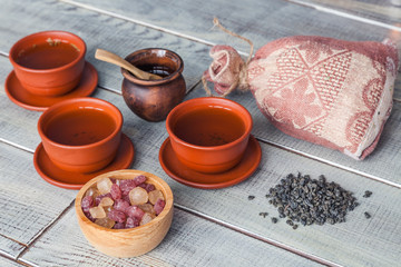 Tea ceremony, tea party. Cups, honey, sugar and vintage cloth sack on a wooden table.