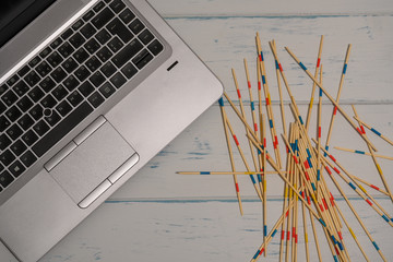 Table with laptop. Mikado game and a stamp