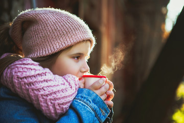  girl drinking hot tea from the thermos