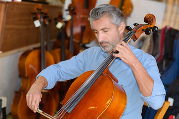 luthier tuning a cello