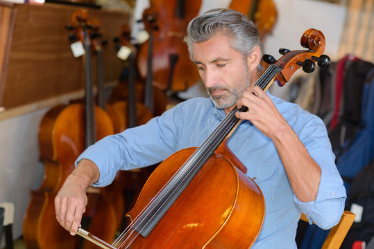 luthier tuning a cello