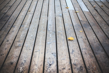 Wood flooring terrace with autumn leaf.