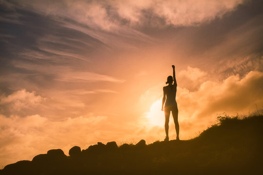 Young Woman Feeling Confident With Her Fist Up In The Air.  