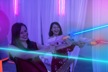 asian teenage playing laser tag indoor