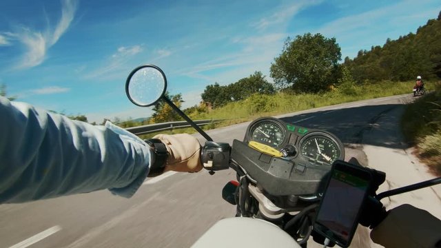 POV of hipster motorcycle driver ride vintage old school motorbike on beautiful epic inspirational sunset road in forest, amazing outdoor fun activity for adventure lovers