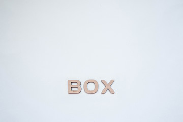 Isolated inscription "box" laid out of stylish wooden letters located on an empty bright and very beautiful background