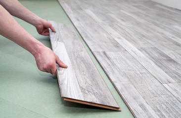 Man laying laminate flooring