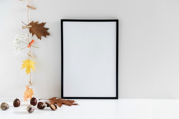 Autumn composition. Photo frame, acorns, dried leaves maple, oak, on white background. Autumn, fall...