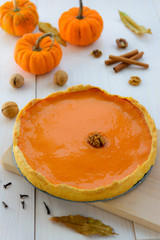 American pumpkin pie on a wooden table