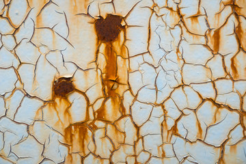 Rusty metal texture background with cracked white-blue paint