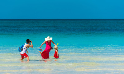 BORACAY, PHILIPPINES - FEBRUARY 28, 2018: Family couple on the beach being photographed. Copy space...