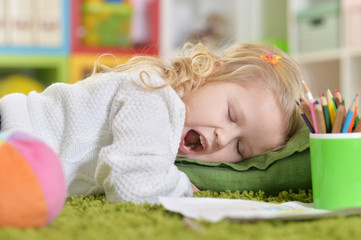 Portrait of a cute little girl yawning