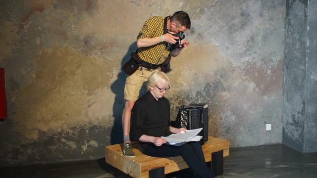 A photographer takes pictures of a albino musician. Home education. Quarantine viral infection COVID 19. Self isolation. Social distance. Online education.