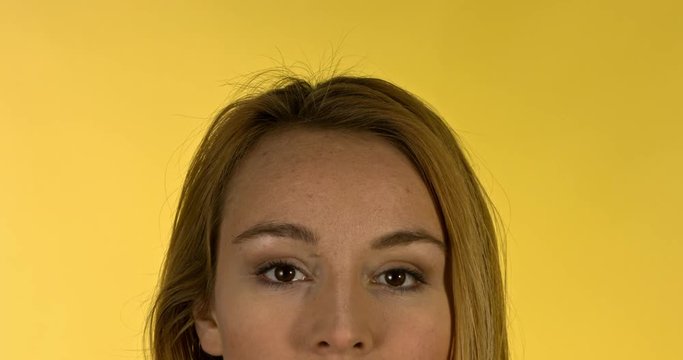 Close up portrait of young seriouse woman looking on camera.