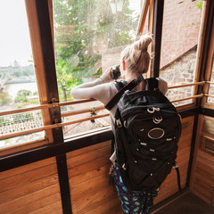 Budapest Castle Hill Funicular. Hungary. Female tourist photographing through glass trailer funicular Budapest panorama