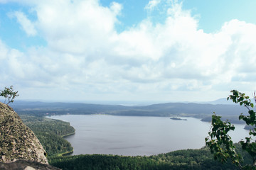 Obraz premium View from the mountain to the lake and forest cloudy sky