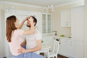 Young couple having fun in the kitchen. Romance in the relationship of man and woman.