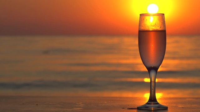 Pouring Champagne In A Glass At Beautiful Sunset In Slow Motion.