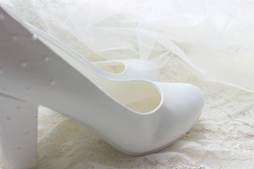 The background of the wedding day. White on white. White shoes. wedding shoes. Bride`s high heels. The fees of the bride. Wedding jewelry.